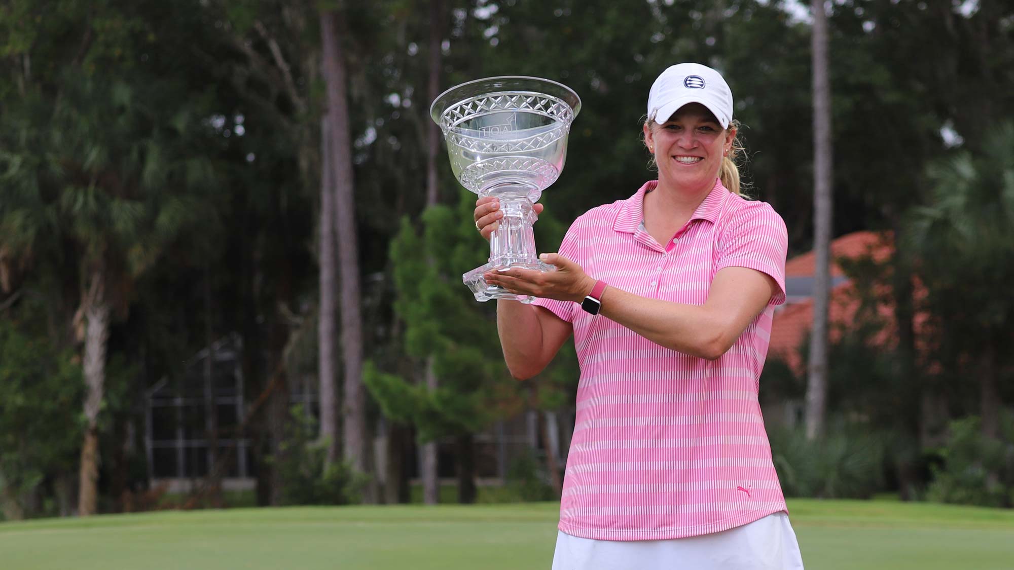 Laura Wearn poses with the 2020 IOA Golf Classic Championship Trophy