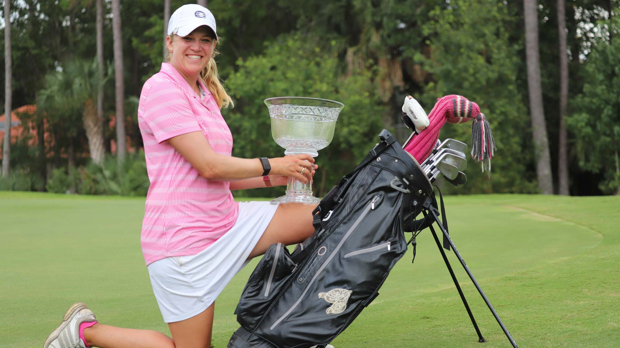 Laura Wearn poses with the 2020 IOA Golf Classic trophy
